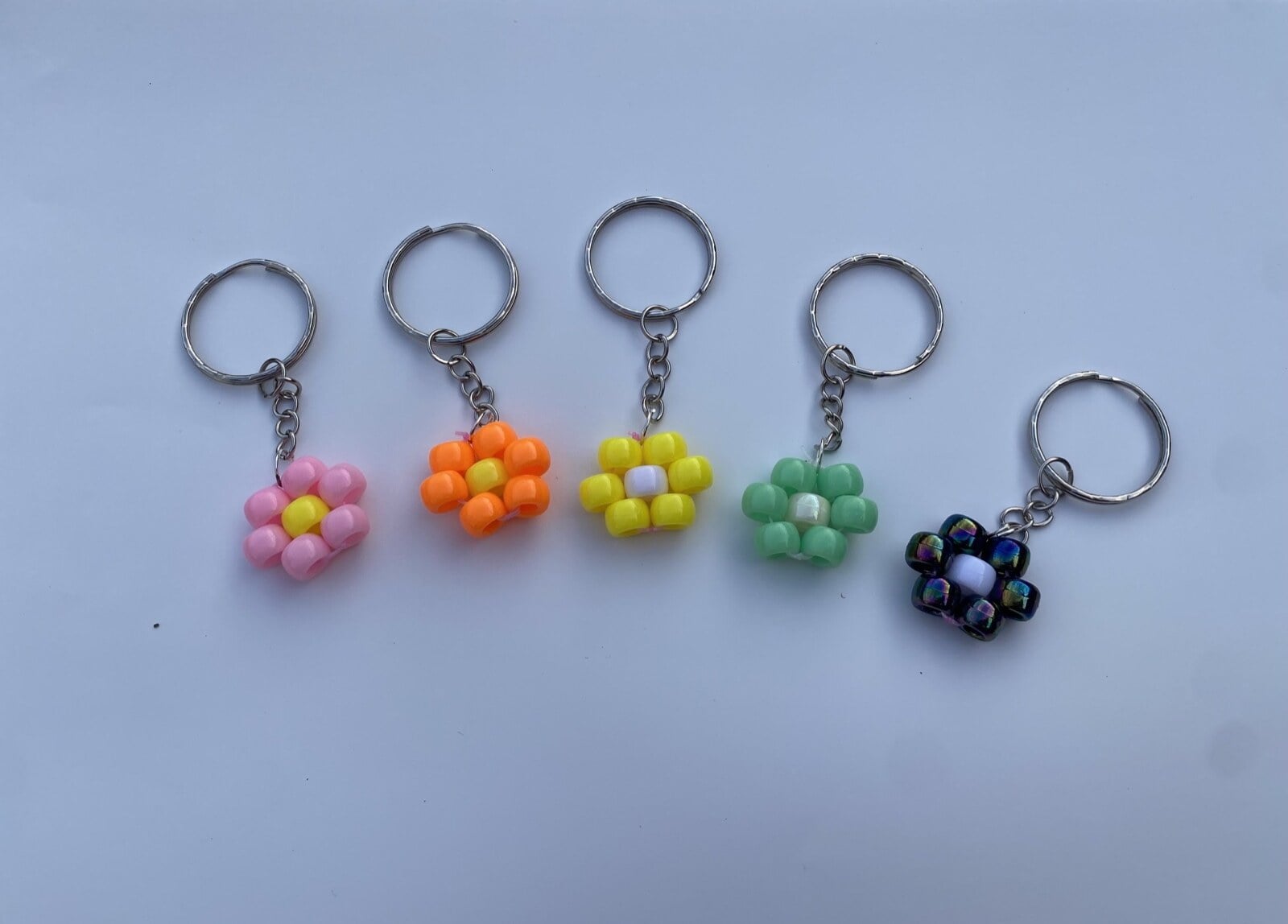 Five colourful beaded flower keyrings handmade by Alice